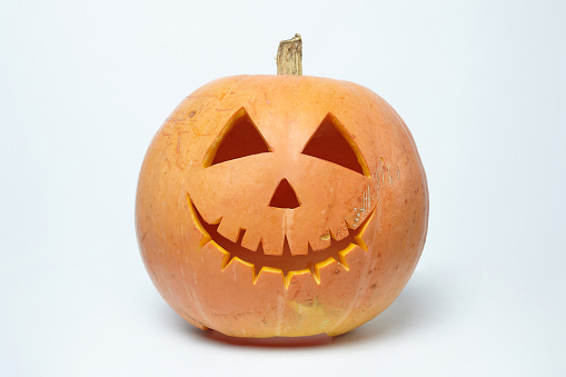 Jack's cheerful lantern, carved from a pumpkin with a smile. photo on a white background.