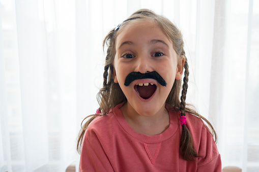 Portrait of a 6 year old wearing a moustache