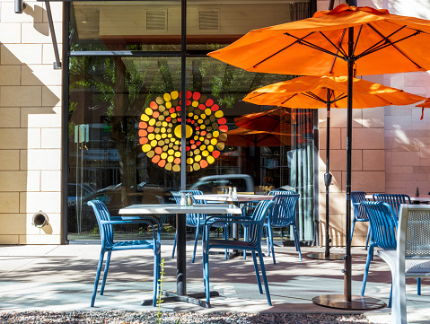 Denver, Colorado - September 16, 2022: Empty cafe with tables and chairs. The street exterior of a restaurant in Cherry Creek district, Denver, Colorado