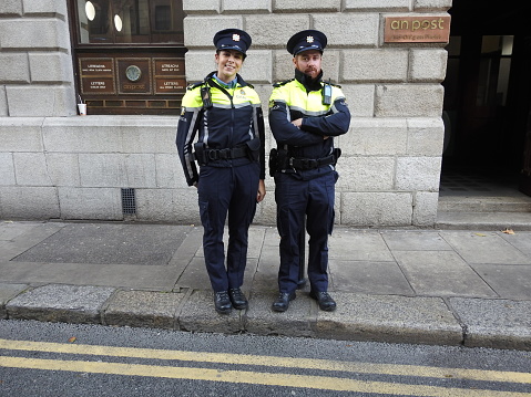 28th October 2022, Dublin, Ireland. Male and female Irish police officers, called An Garda Siochana, outside the GPO on O'Connell Street, Dublin, wearing the new police uniform, introduced in 2022.