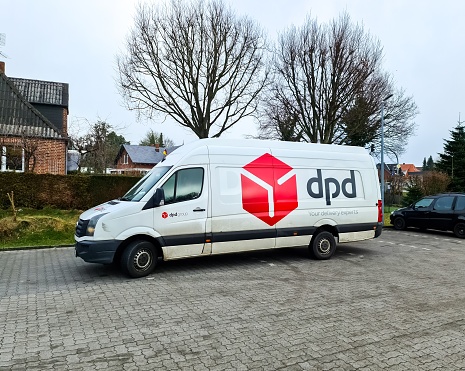 Kiel, Germany - 28.October 2022: A white van of the German delivery service DPD parking in front of a house