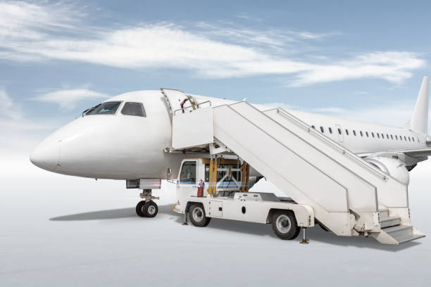istock White passenger jet plane with an aircraft steps isolated on bright background with sky 1437323916