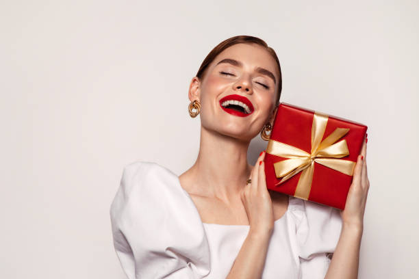 istock Beautiful emotional woman holding present box 1437325473