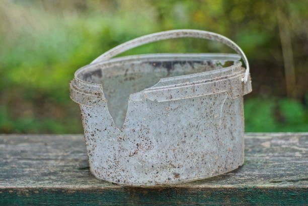 istock one broken old dirty gray white plastic bucket with a hole in the cracks 1437326215