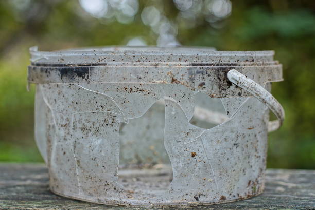 istock one broken old dirty gray white plastic bucket with a hole 1437326247
