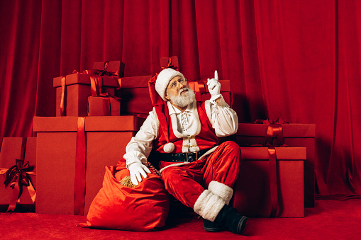 Real Santa Claus opening gift bag