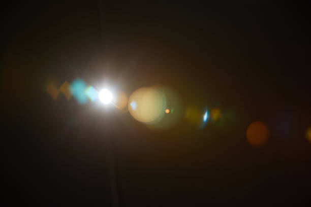 image of abstract natural lens flare on black background - efeito de refracção de luz imagens e fotografias de stock