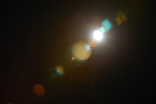 Image of abstract natural lens flare on black background