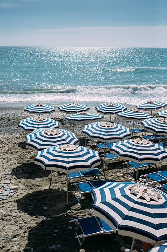 Beautiful beach with empty beach seat and umbrellas at small town of Monterosso in the Cinque Terre Park in Italy stock photo