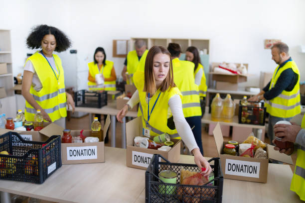 istock Volunteers distributing food contributions into boxes 1437334758