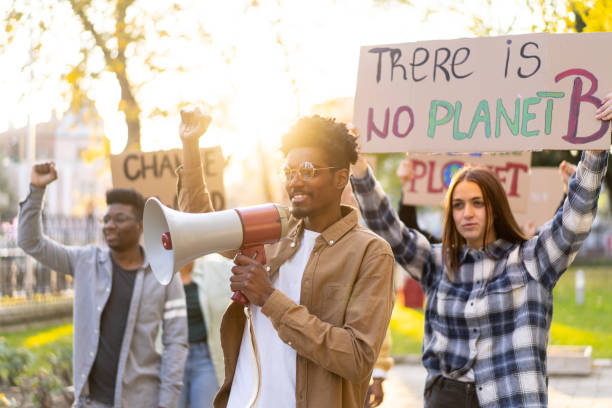 istock An organized group of protestors in a park, holding banners 1437334788