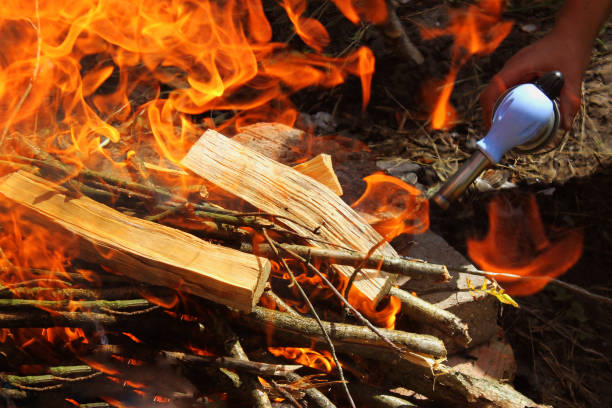 gas burner kindles coals, kindle a fire with a burner, a flame from a burner, ready-made coals in the brazier, make a fire on a hike, Preparing coals for barbecue, A jet of fire from a gas burner