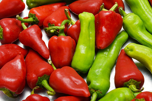 High angle view group of green and red chili peppers