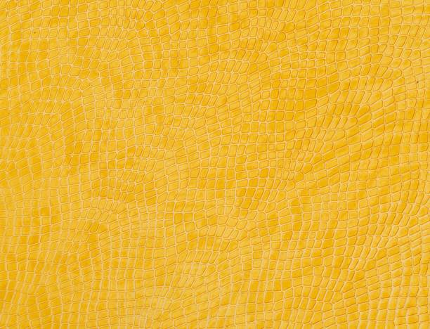 istock Closeup shot of a patterned leather yellow surface - perfect for background 1437348316