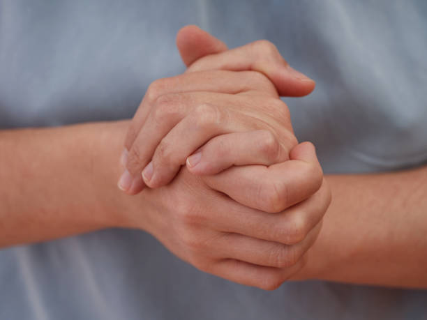 istock A woman holding her hands in front of herself 1437350135