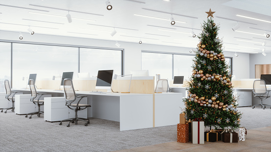 Christmas tree and gifts in a modern office space.