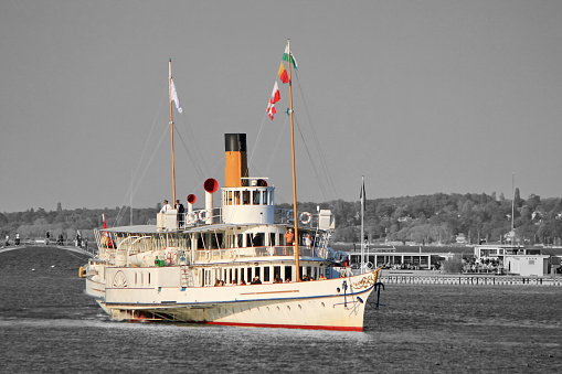Famous old white steamboat on Geneva lake by sunset, Switzerland.