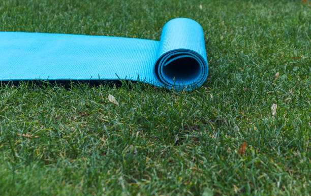 istock Partially opened yoga mat on the grass 1437366983