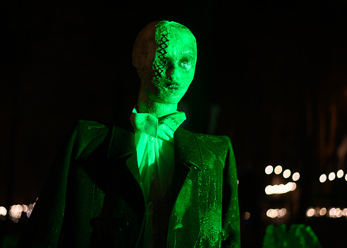 Green man in black suit zombie Halloween scary night instalation
