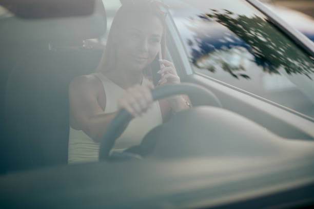 istock Young woman using phone in the car 1437368353