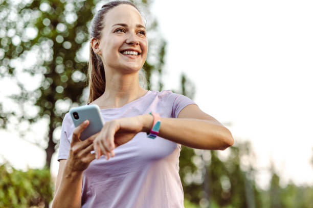 istock Young woman checking performance on her smart watch during training in the park 1437370147