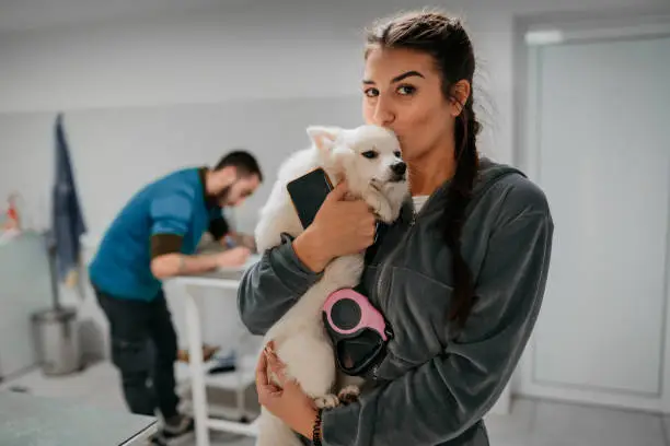 Photo of Woman with dog at vet