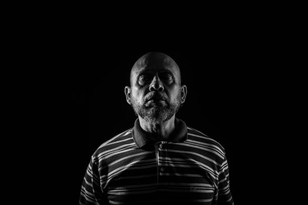 istock Handsome bald mature man with beard, wearing casual shirt. 1437371624