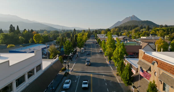 Aerial View of Street Traffic in Downtown Mount Shasta, California Aerial establishing shot of Mount Shasta, California on a clear day in autumn. Mount Shasta is a small mountain town in the Siskiyou County of California. small town america stock pictures, royalty-free photos & images