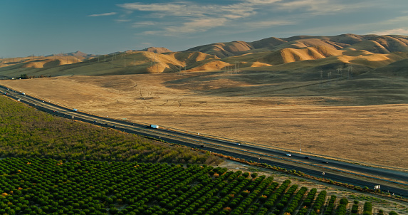 Aerial shot of traffic on interstate 5 in Stanislaus County, California on a sunny afternoon in autumn.
