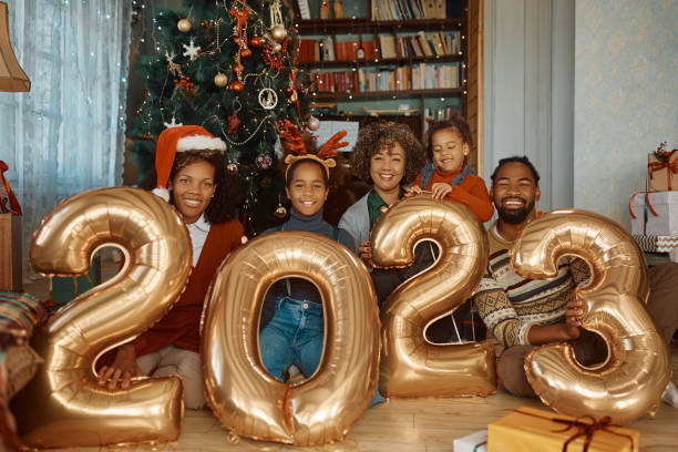 happy black extended family with 2023 balloons on new year's day at home. - new year people family offspring imagens e fotografias de stock