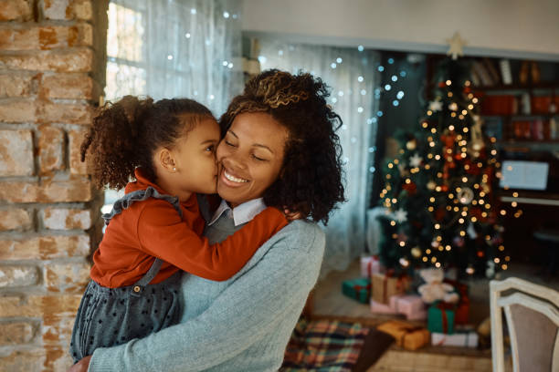 istock Affectionate mother and daughter spending Christmas together at home. 1437377499