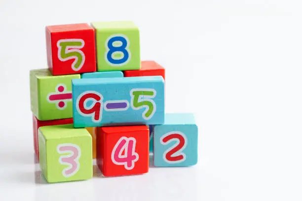 Photo of Number wood block cubes for learning Mathematic, education math concept.