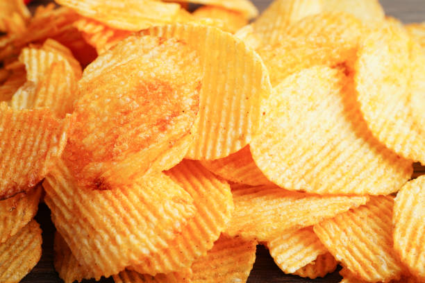 istock Potato chips in open bag, delicious BBQ seasoning spicy for crips, thin slice deep fried snack fast food. 1437384816
