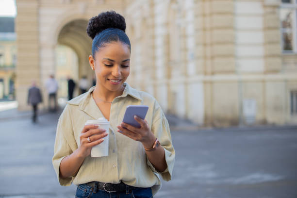 istock Happy young woman using phone 1437387531