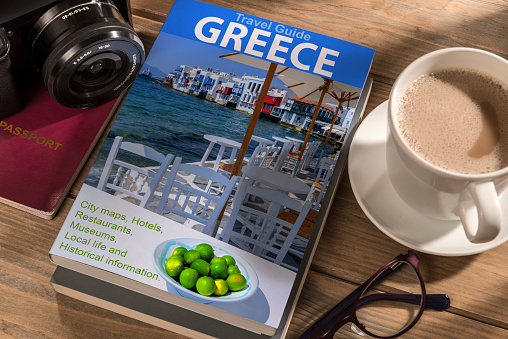 Travel Guide to Greece on the table. Photographer's own book cover design.