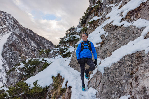 istock A Caucasian Trail Runner Pauses At Mountain Top In Winter 1437392311