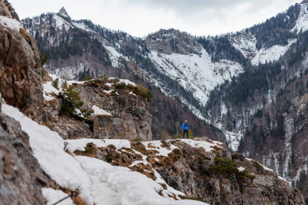 istock A Caucasian Trail Runner Pauses At Mountain Top In Winter 1437392325