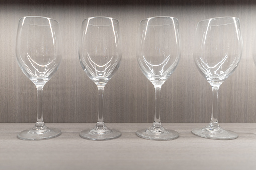 A neat row of empty clear glass goblets