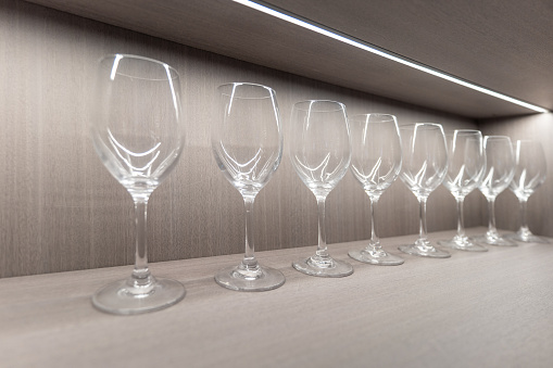 A neat row of empty clear glass goblets
