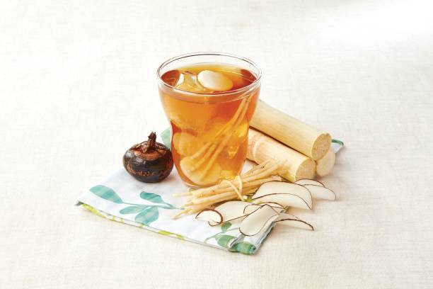 Bamboo Cane, Chuck Root and Horseshoe Sea Coconut Drink served in a cup isolated on napkin side view of hong kong food
