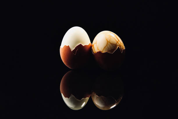 istock One boiled egg and one tea egg with half the shell peeled - stock photo 1437405577