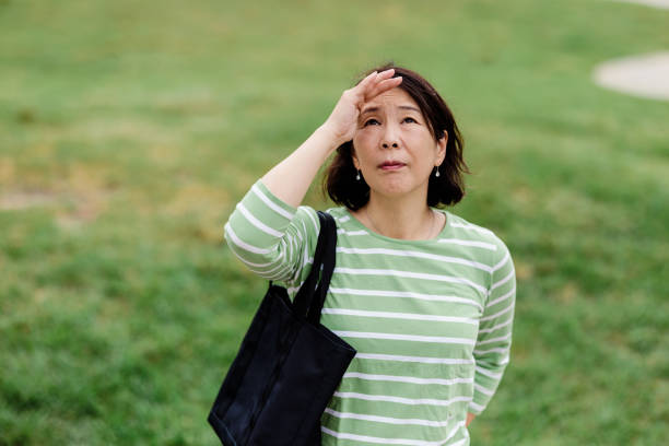 istock Woman outdoors looking up 1437410478