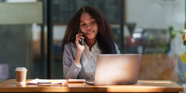 istock Asian businesswoman talking with client on mobile phone working at office 1437412185