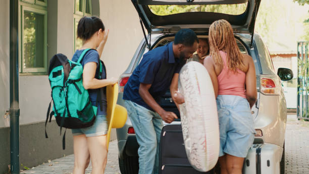 istock Multiethnic people loading car trunk with voyage luggage 1437420553