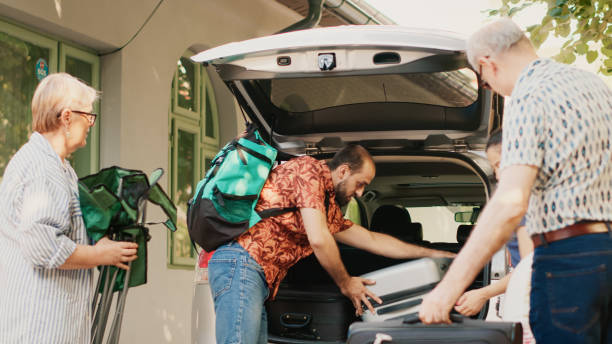 istock Family loading voyage baggage and trolleys inside car trunk 1437420572
