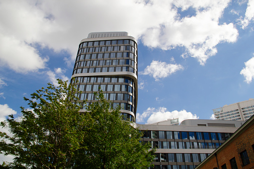 Autumn Sunny Cloudy Blue Sky Cityscape, Sky Park Bratislava Designed by Zaha Hadid Architects, Sky Park Bratislava Office Building (2020) Designed by Vietzke and Borstelmann Architects as Business Partner, Ornamental Trees in the Foreground, Panorama Towers Bratislava Skyscrapers Designed by RBTA Ricardo Bofill Taller de Arquitectura (2014) in the Background, Nivy Shopping Mall (2021) and Eurovea Shopping Mall (2010) Neighborhood, in Staré Mesto as 1st District, Bratislava, Slovakia, Central Europe in September 2022 - Sky Park is a 21st century residential and financial district with skyscrapers, green parks and all public spaces, one of the defining achievements of the modern and futuristic smart city architectural character of Bratislava, the capital of Slovakia. The first phase of construction took place between 2010 and 2020, the second phase has not yet been completed in 2022. The Sky Park Bratislava was realized based on the plans of Zaha Hadid Architects.