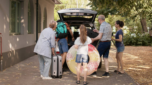 istock People putting luggage and trolleys inside car 1437420654