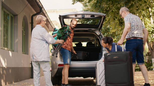 istock Big family loading voyage baggage in vehicle trunk 1437420676