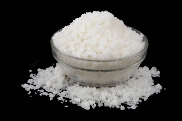 istock Glass bowl with salt isolated on black 1437423022