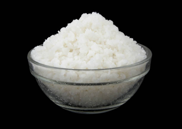 istock Glass bowl with salt isolated on black 1437423025